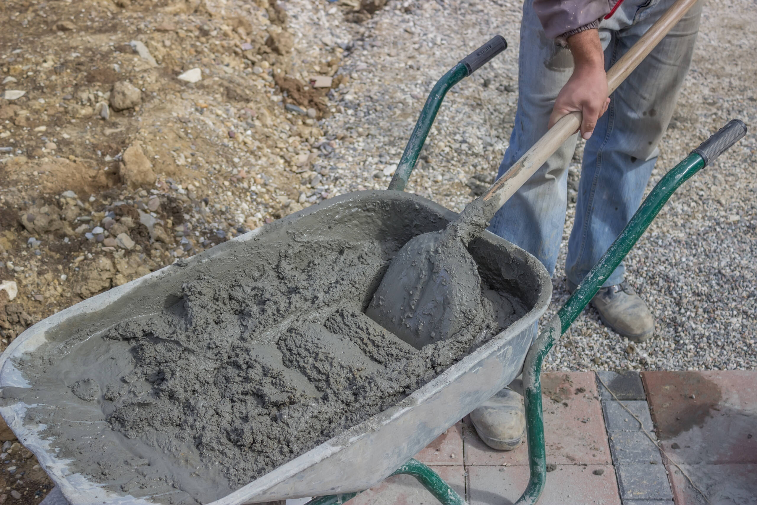 worker with concrete mortar in wheelbarrow 5 New Mix Concrete